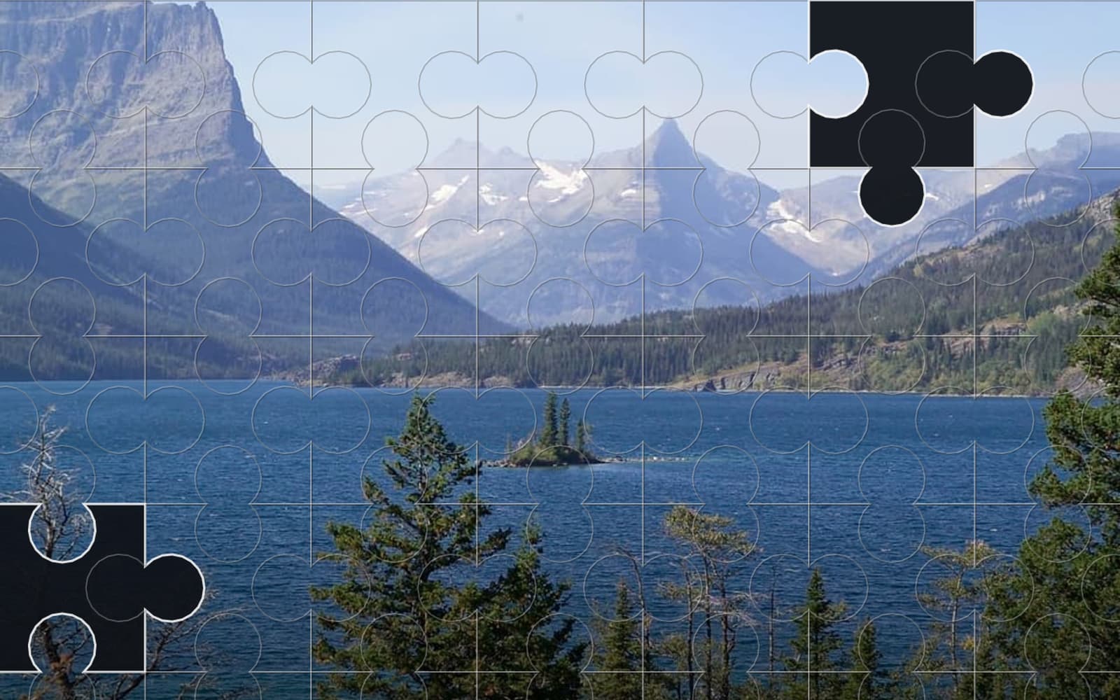 A mountain lake photograph part-solved in Jigsaw.ug, two pieces still missing from the board